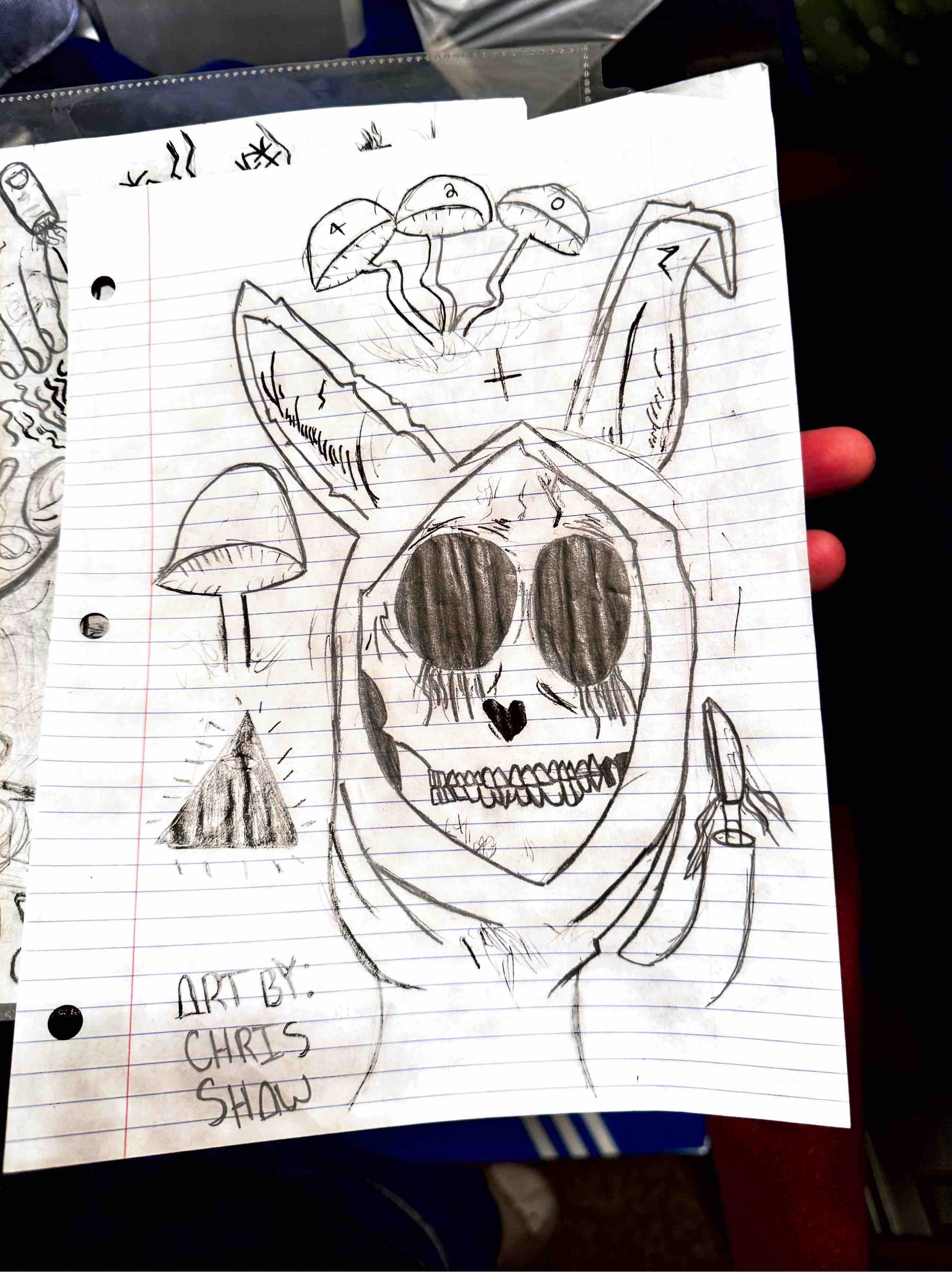 Original Chris Shaw notebook sketch of a skull, mushrooms, and a candle.